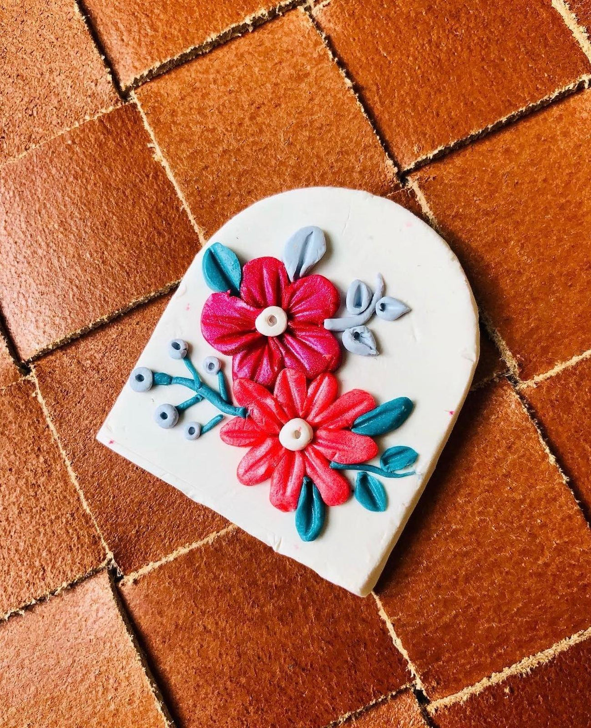Fuchsia Arch Pendant: white arch with fuchsia and coral flowers and teal leaves