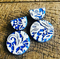 Indigo Lace Drops: blue and white lace-pattern earrings on wood