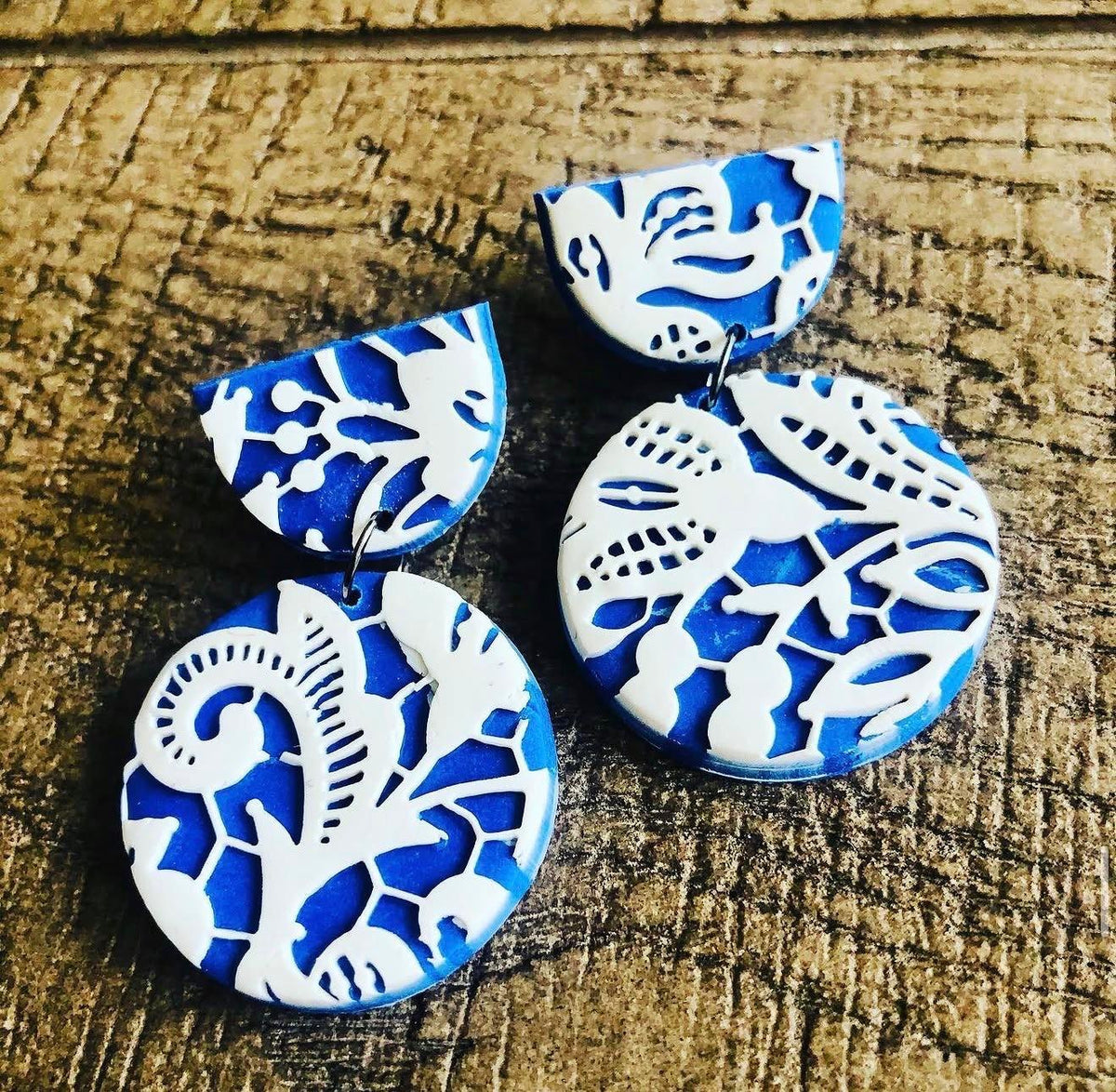 Indigo Lace Drops: blue and white lace-pattern earrings on wood