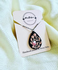Midnight Songbird Pendant: black teardrop pendant with a bird and blush roses on a NavRatna card