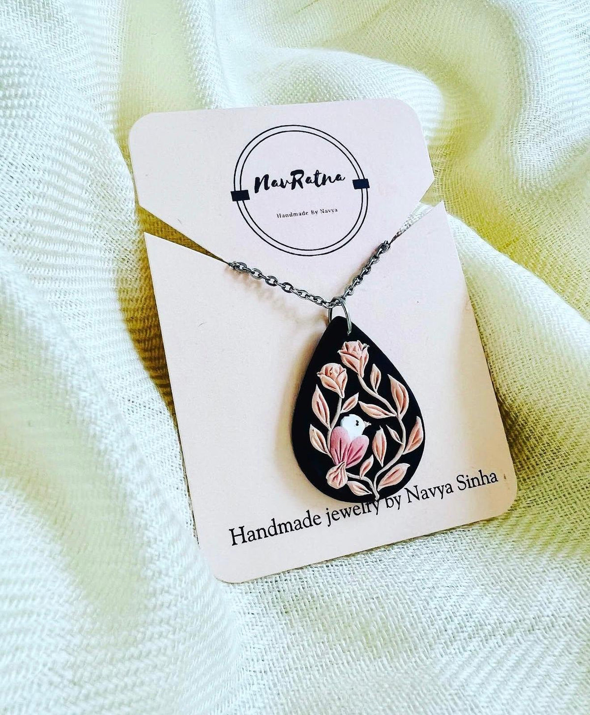 Midnight Songbird Pendant: black teardrop pendant with a bird and blush roses on a NavRatna card