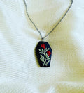 Noir Rose Pendant: black coffin-shaped pendant with red roses on a chain