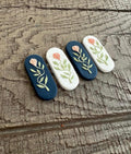 Rose Vine Bar Earrings in navy and white, with peach roses on sage vines