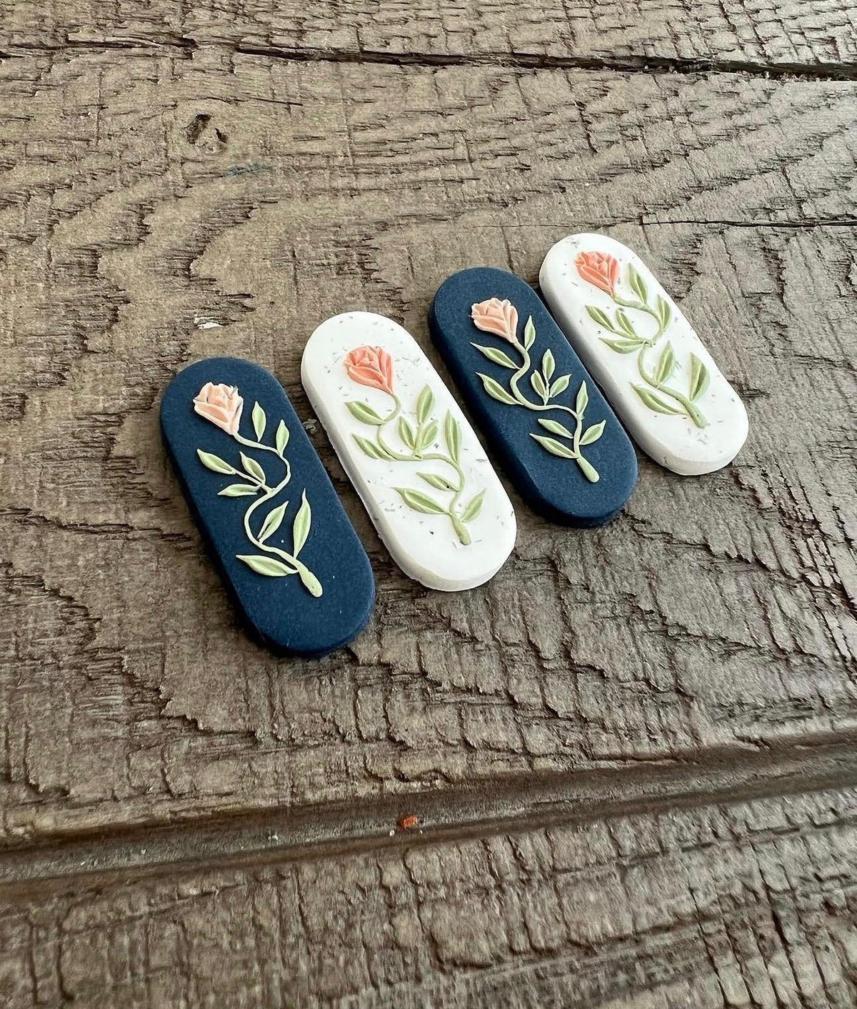 Rose Vine Bar Earrings in navy and white, with peach roses on sage vines