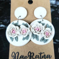 White Camellia Drops: white round earrings with pink-centered camellias on a NavRatna card